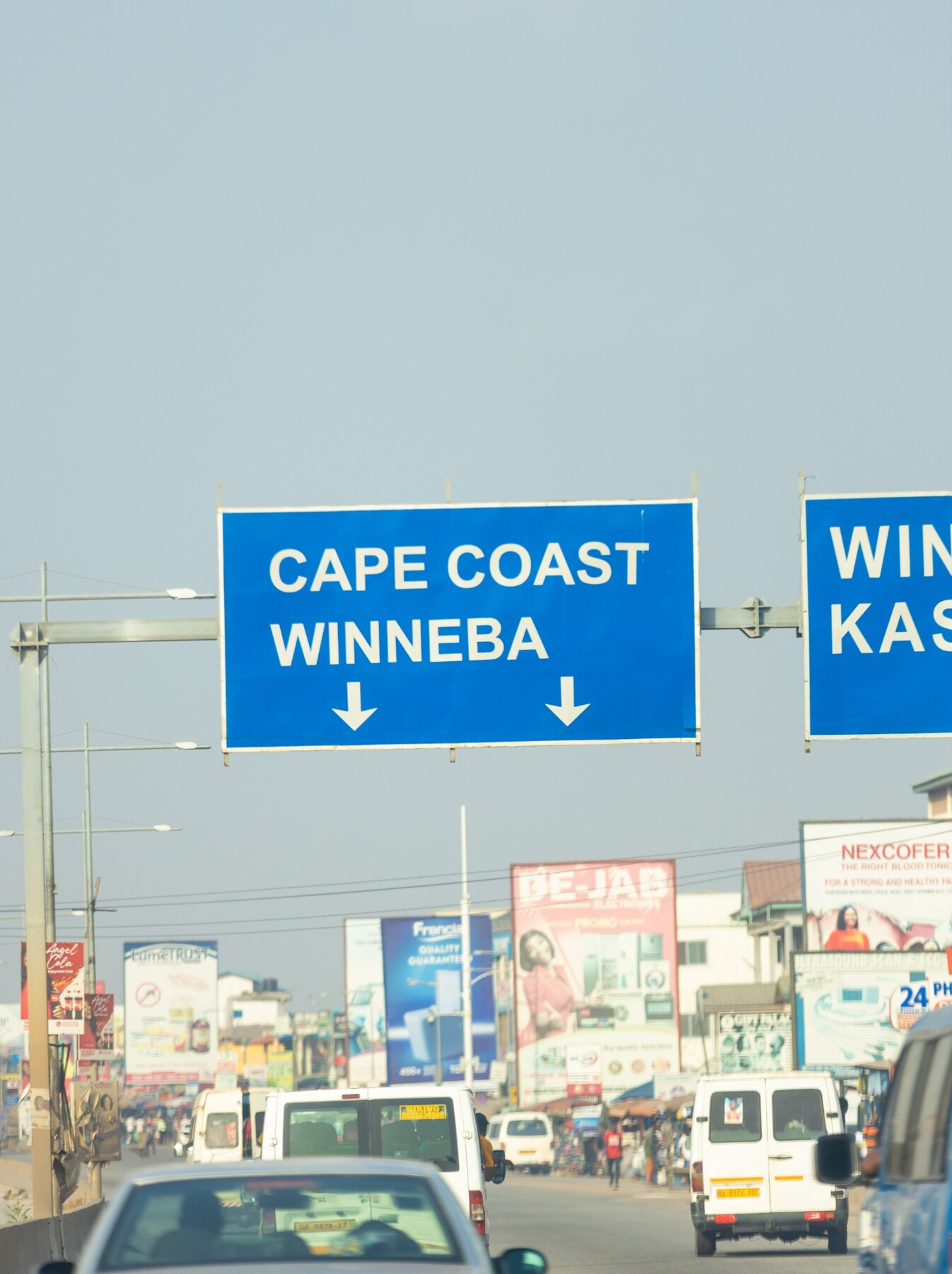 Road signs pointing toward Cape Coast and Winneba in Ghana