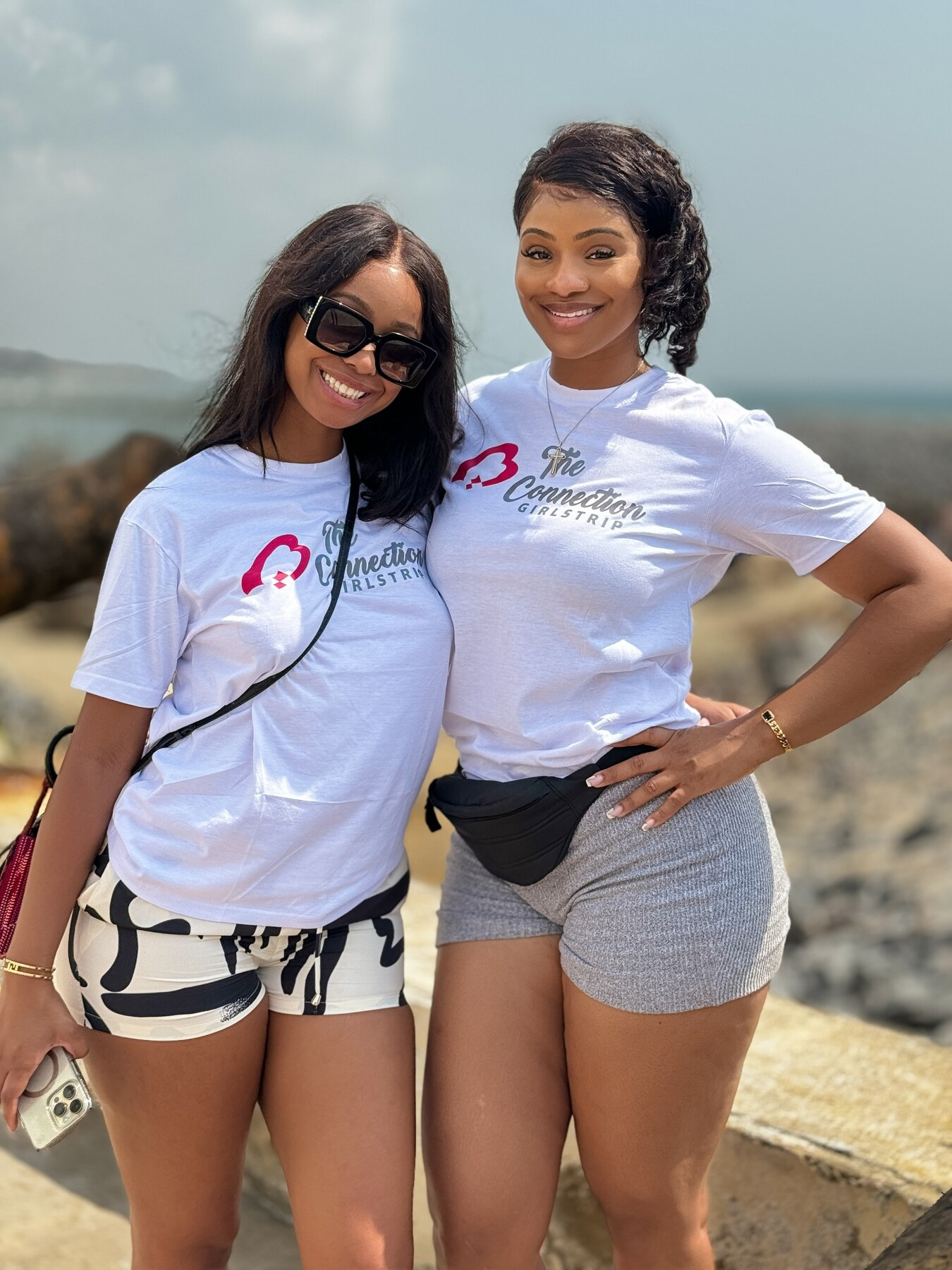 Two guests smiling together beside the Ghanaian coast