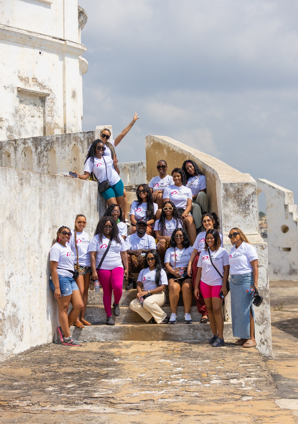 A group of guests gathered at a historic coastal site in Ghana